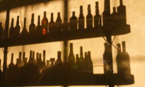 shadows of bottles on shelves