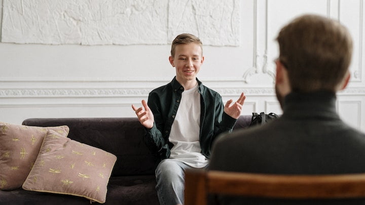 A young man in therapy with a male therapist in an alcohol rehab in Newcastle