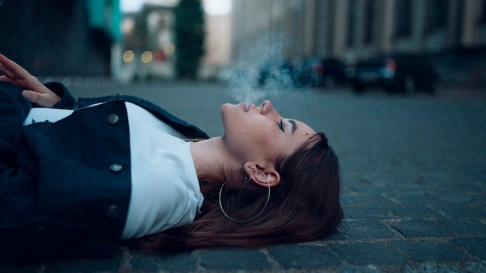 Woman lying down smoking