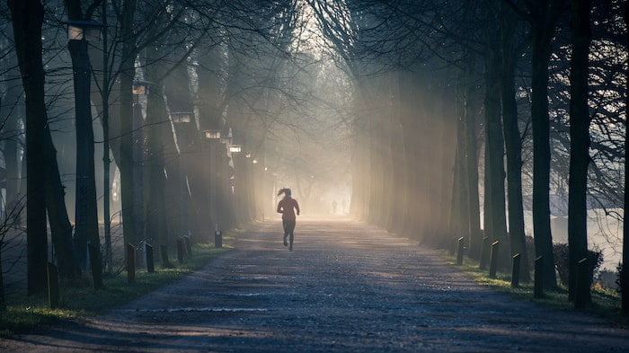 Woman running in woods