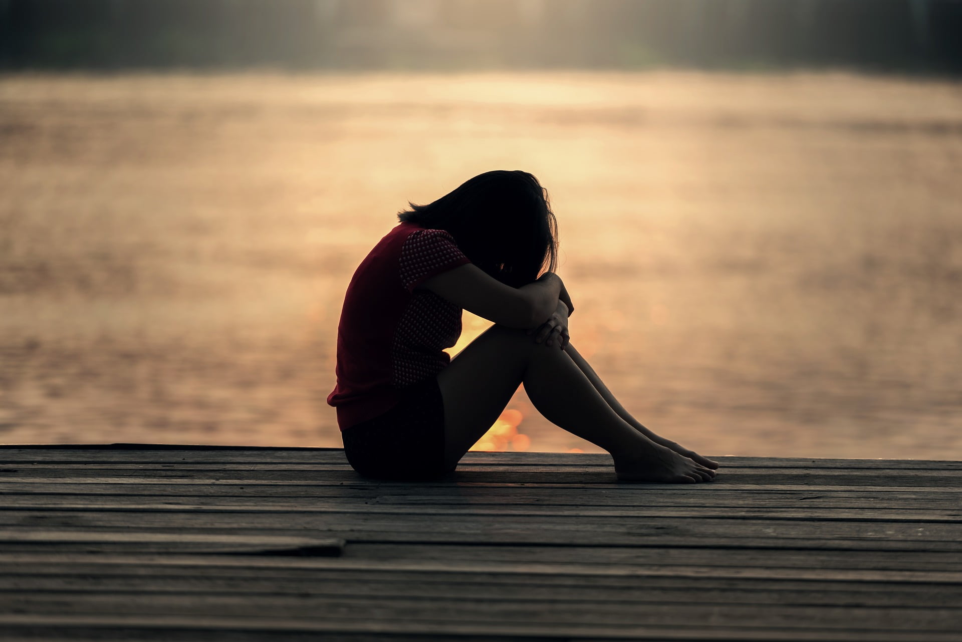 girl thinking by lake