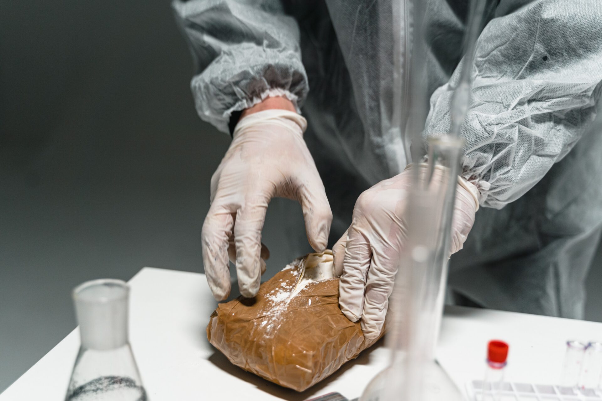 man in gloves handling drugs