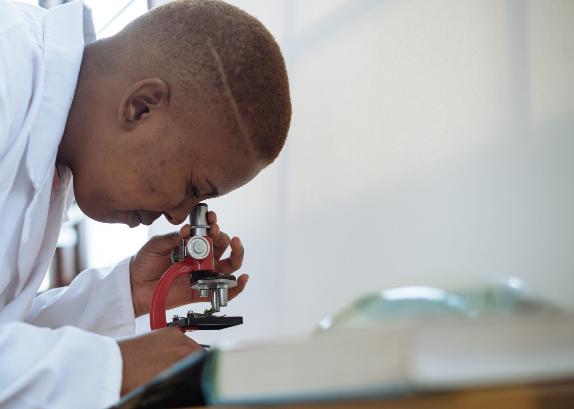 scientist in lab studying a sample