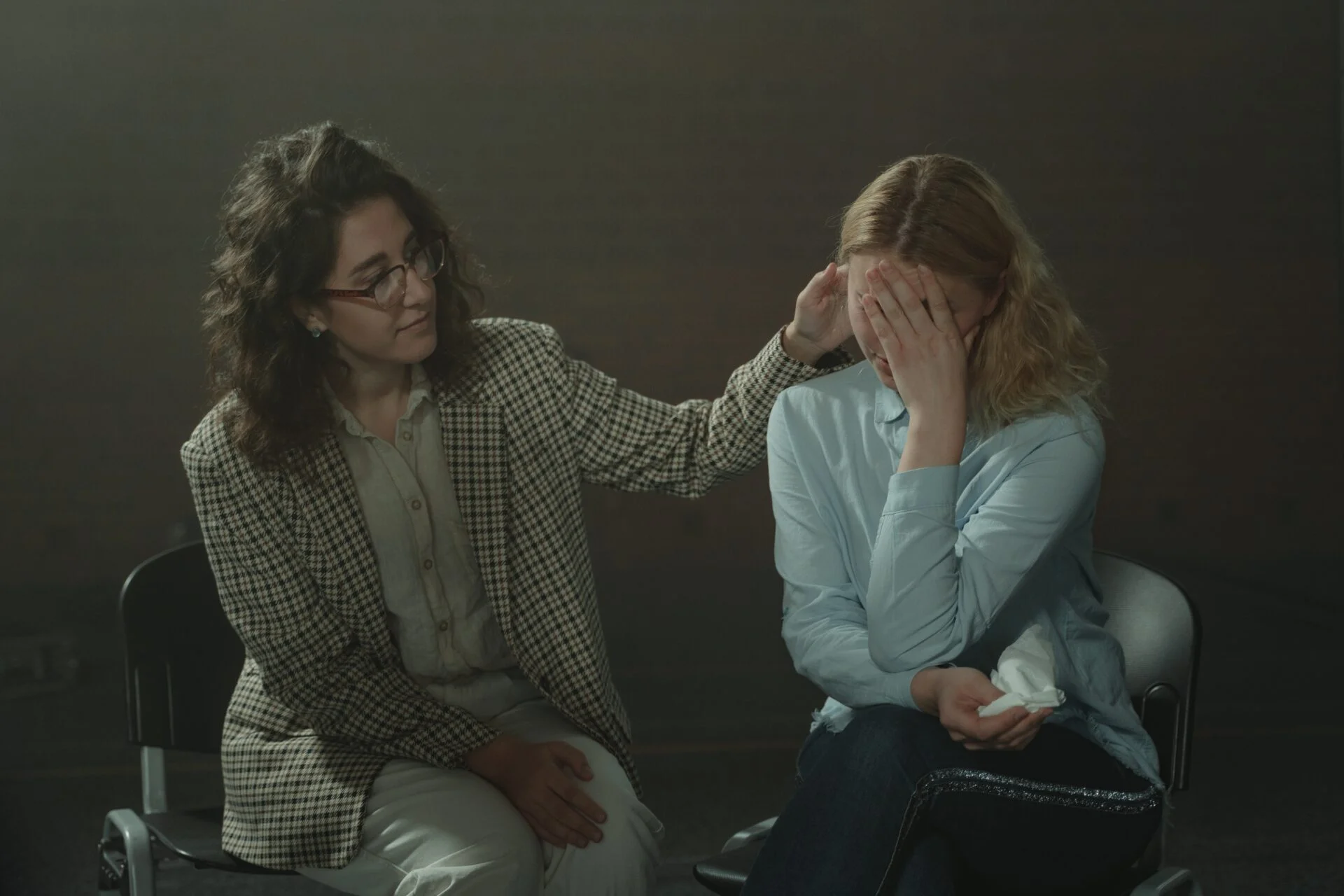 person comforting another in therapy