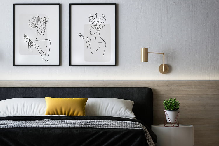 A bedroom with art on the walls