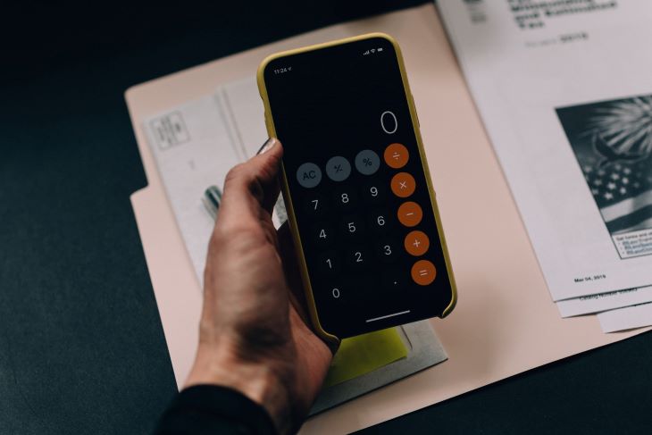 A phone calculator held above some documents at a rehab in Oxford