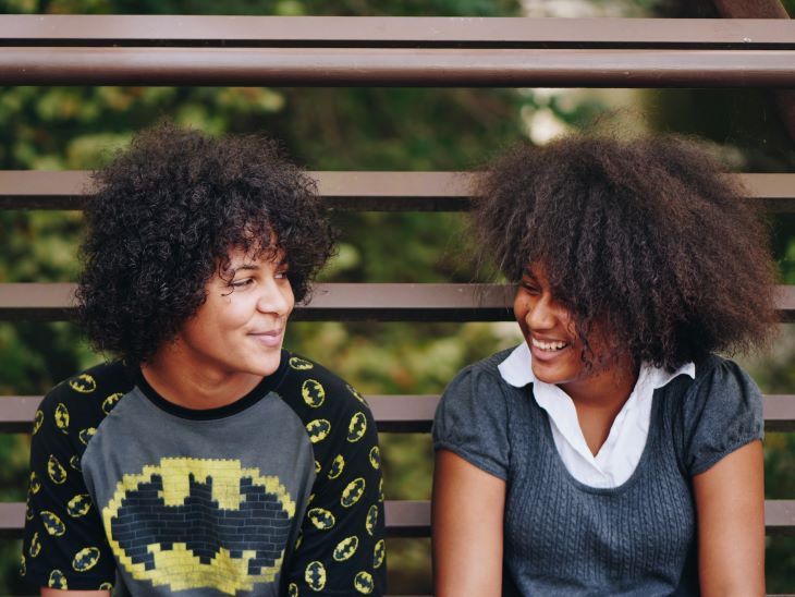 Two women chatting and smiling on a bench in Buckinghamshire