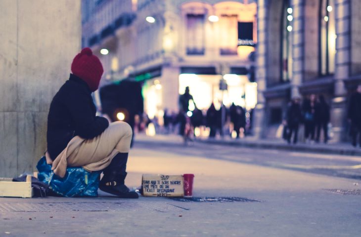A homeless person sitting on the street