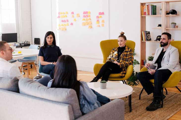 A group of people sitting in armchairs