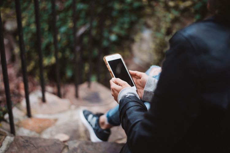 A person holding a phone in Leeds