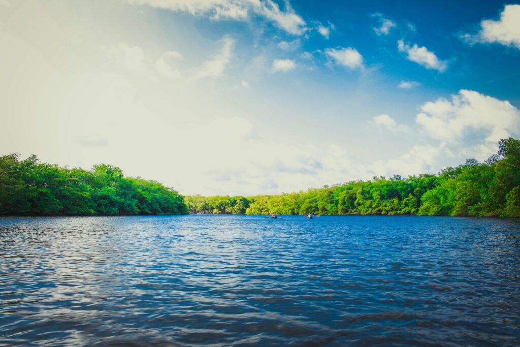 A vast river with a blue sky and clouds