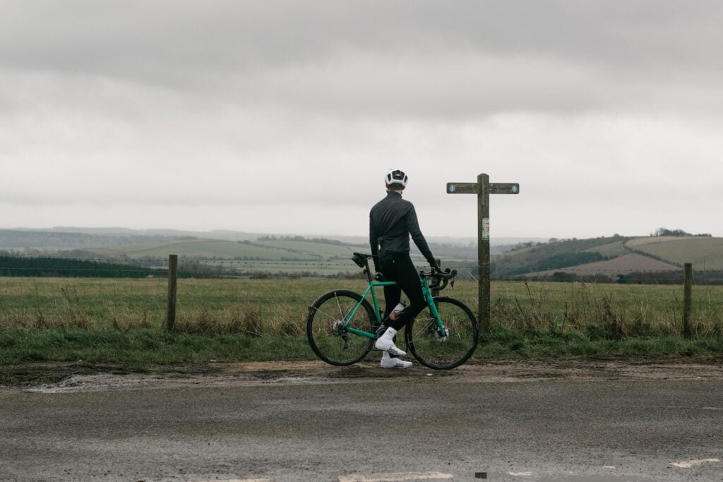 Petersfield - a cyclist by a multiway sign in the countryside