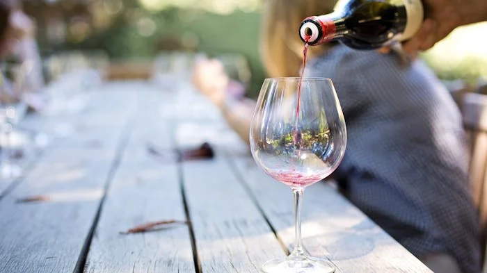 A glass of wine being poured