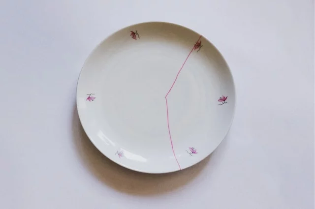 Plate repaired with pink paint in the Kintsugi method