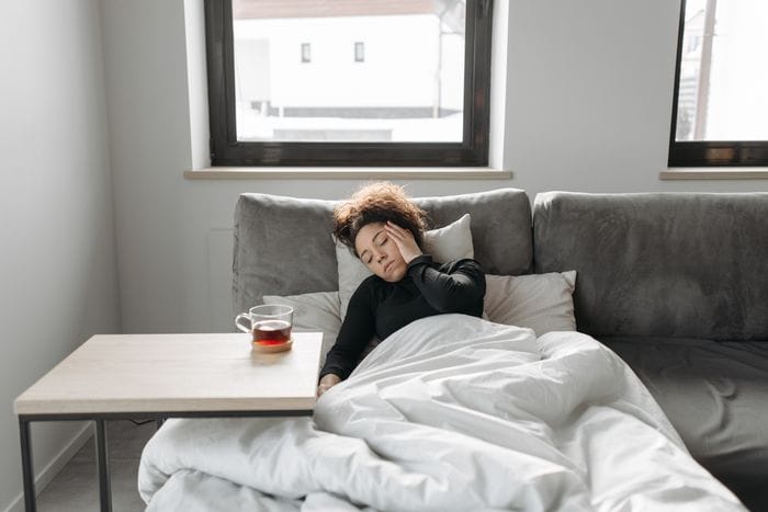 Woman struggling with a spinning head after drinking