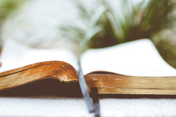 A book with gold pages on a table